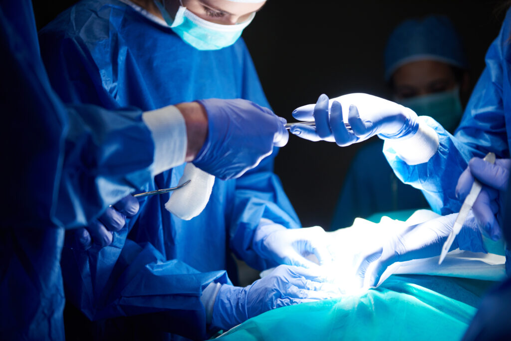 Surgeons discussing patient care and surgical drain tracking during post-operative recovery